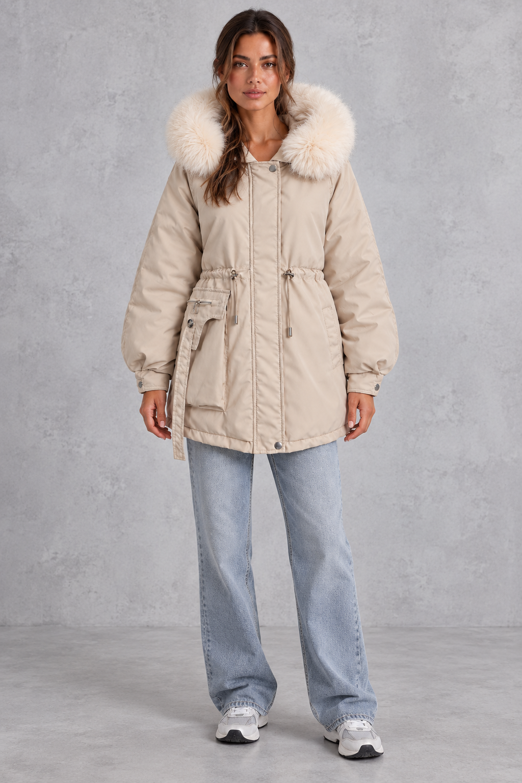 Women’s hooded parka coat with soft faux fur trim, an adjustable drawstring waist, long sleeves and a longer curved hem.