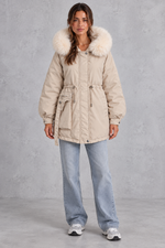 Women’s hooded parka coat with soft faux fur trim, an adjustable drawstring waist, long sleeves and a longer curved hem.