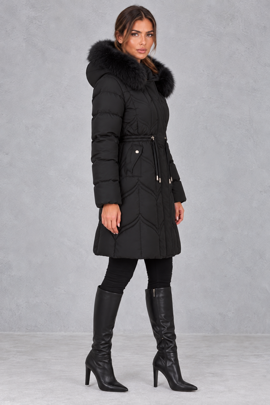 Women’s padded puffer parka with a plush faux fur-trimmed hood, adjustable drawstring waist, long sleeves and practical front pockets.