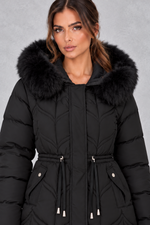Women’s padded puffer parka with a plush faux fur-trimmed hood, adjustable drawstring waist, long sleeves and practical front pockets.