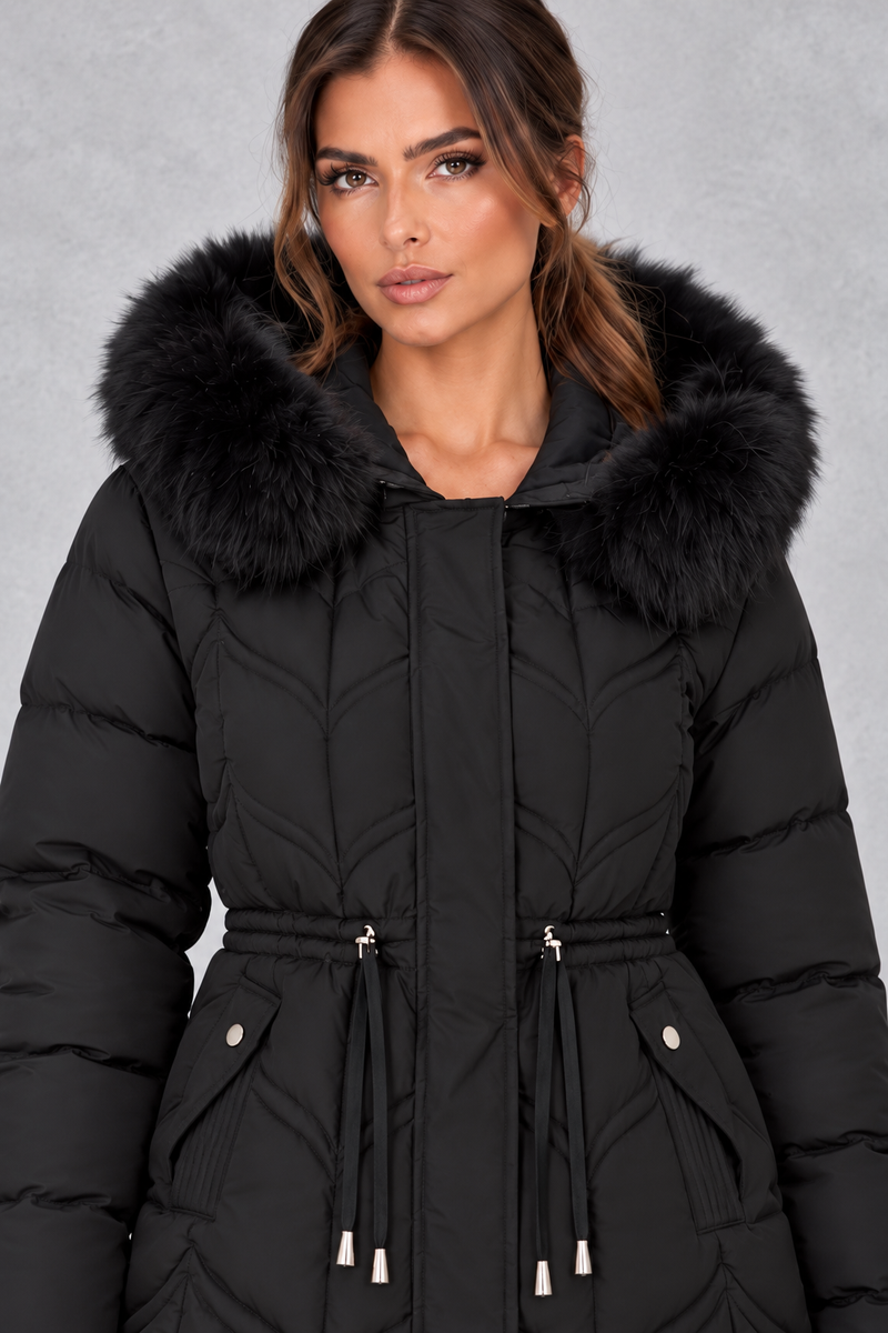 Women’s padded puffer parka with a plush faux fur-trimmed hood, adjustable drawstring waist, long sleeves and practical front pockets.