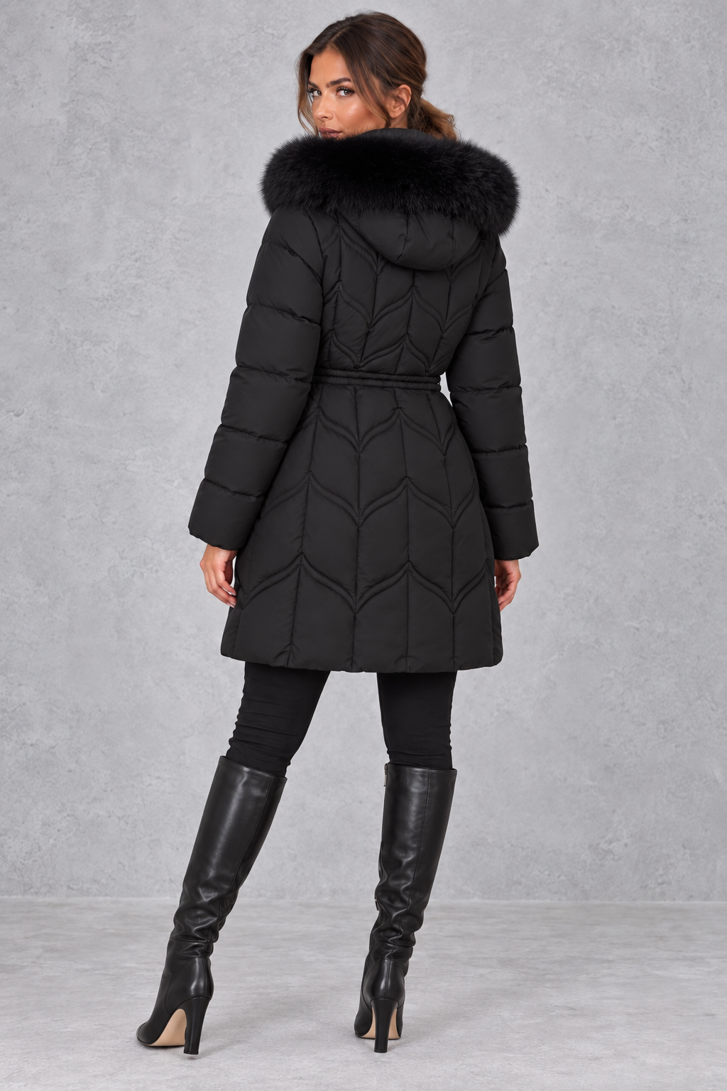Women’s padded puffer parka with a plush faux fur-trimmed hood, adjustable drawstring waist, long sleeves and practical front pockets.