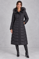 Women’s longline puffer coat with a plush faux fur-trimmed hood, chevron quilting, padded sleeves and a gently defined waist.