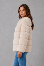 Women’s plush faux fur jacket with an elegant statement collar, relaxed silhouette and soft textured finish for autumn and winter styling.