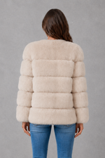 Women’s plush faux fur jacket with an elegant statement collar, relaxed silhouette and soft textured finish for autumn and winter styling.