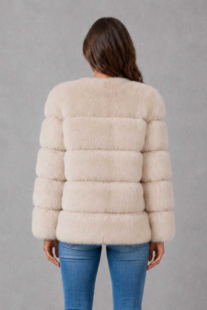 Women’s plush faux fur jacket with an elegant statement collar, relaxed silhouette and soft textured finish for autumn and winter styling.