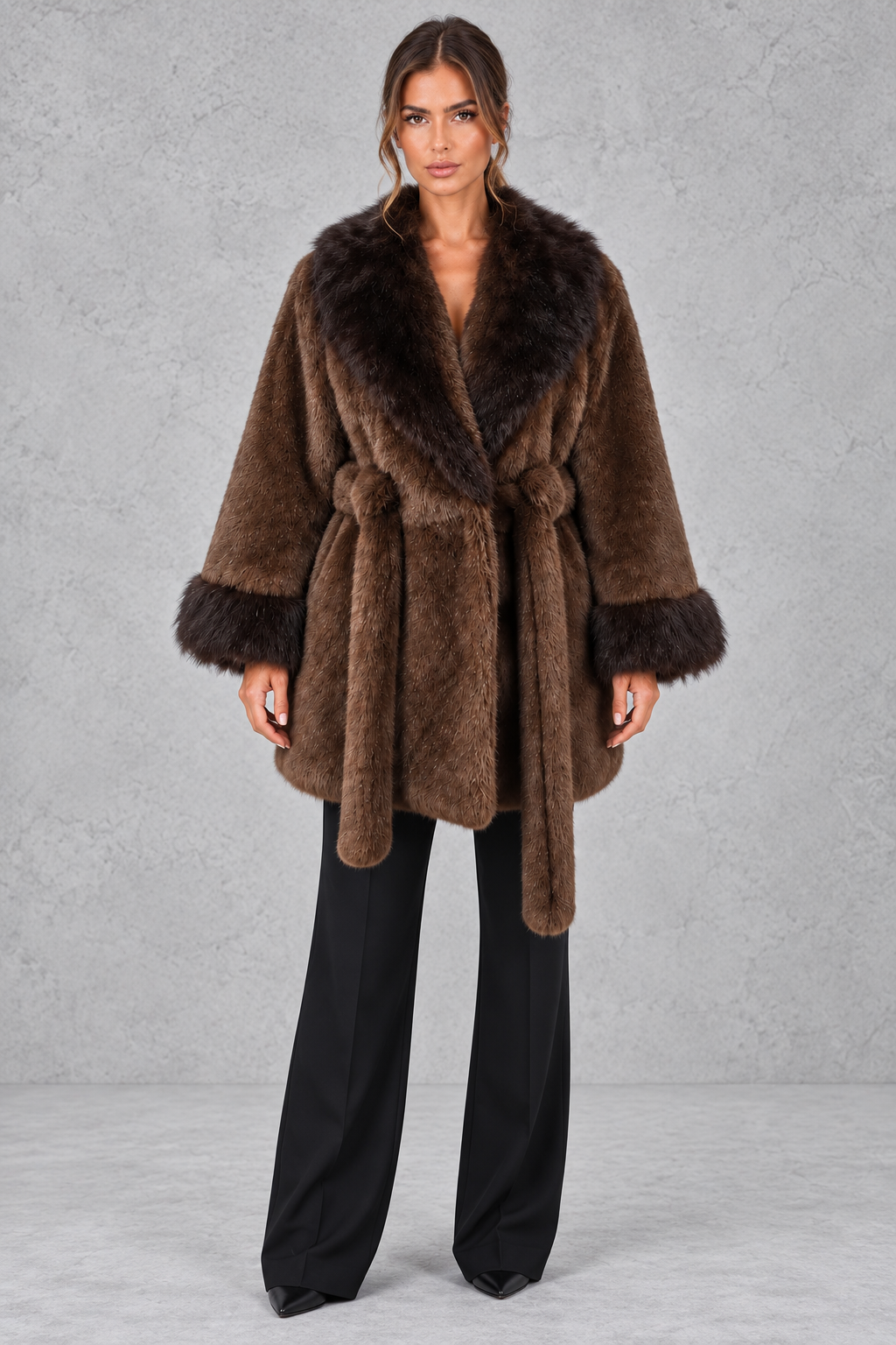 Women’s belted coat with an oversized faux fur shawl collar, matching faux fur cuffs, wrap-style front and defined waist.