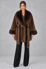 Women’s belted coat with an oversized faux fur shawl collar, matching faux fur cuffs, wrap-style front and defined waist.