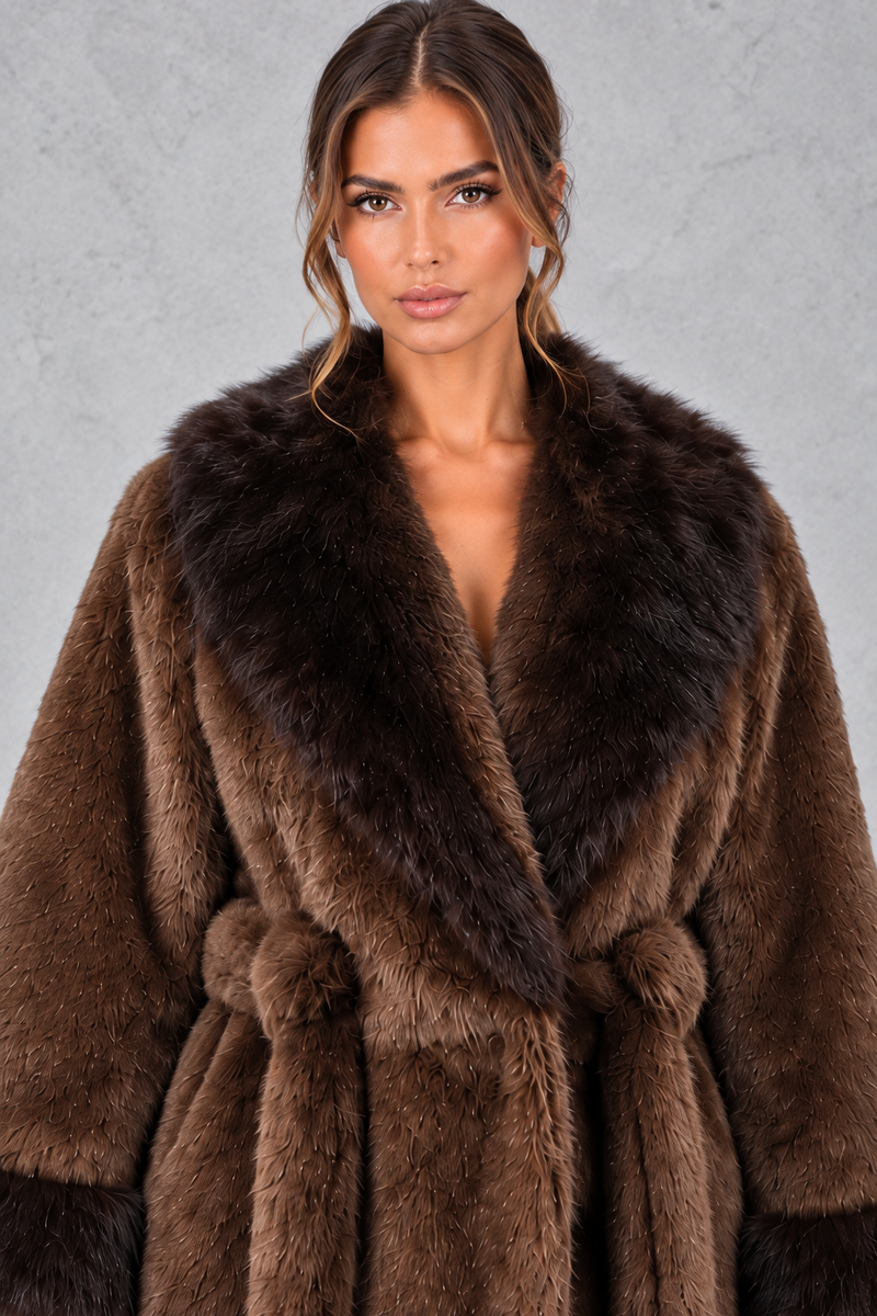 Women’s belted coat with an oversized faux fur shawl collar, matching faux fur cuffs, wrap-style front and defined waist.