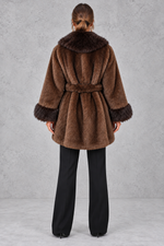 Women’s belted coat with an oversized faux fur shawl collar, matching faux fur cuffs, wrap-style front and defined waist.