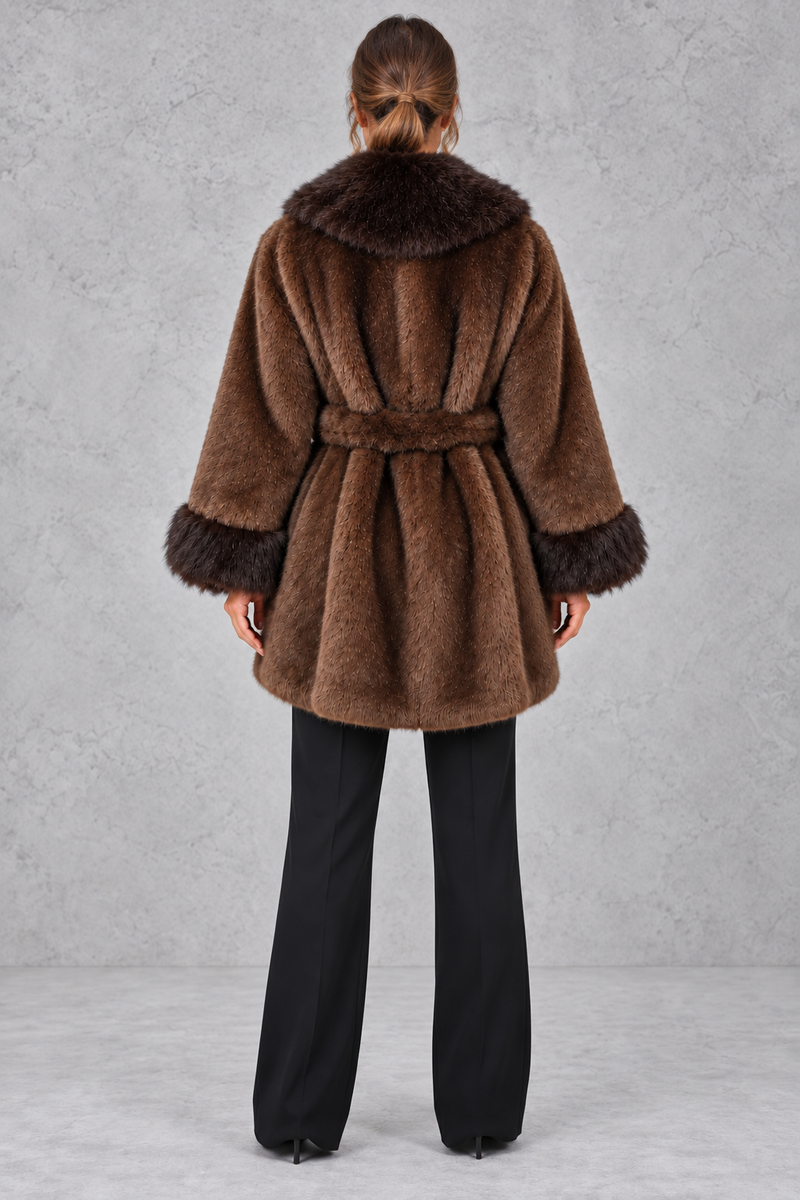 Women’s belted coat with an oversized faux fur shawl collar, matching faux fur cuffs, wrap-style front and defined waist.