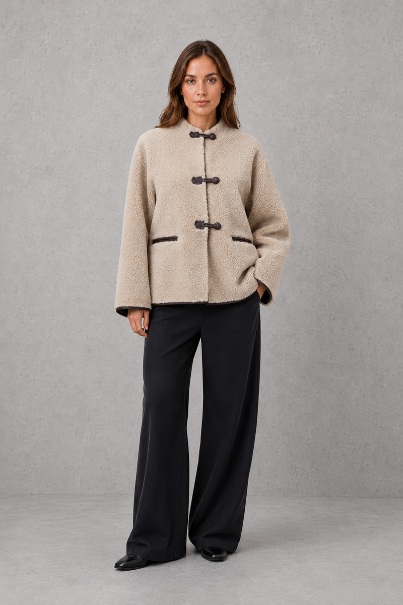Women’s oversized faux fur toggle jacket with contrast trim, front pockets and a warm textured finish