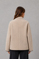 Women’s oversized faux fur toggle jacket with contrast trim, front pockets and a warm textured finish