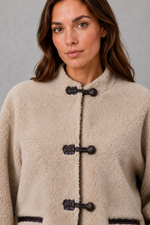 Women’s oversized faux fur toggle jacket with contrast trim, front pockets and a warm textured finish