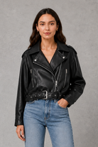 Women’s faux leather biker jacket with an asymmetric zip front, adjustable belted waist, zipped pockets and a relaxed cropped moto silhouette.