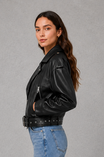 Women’s faux leather biker jacket with an asymmetric zip front, adjustable belted waist, zipped pockets and a relaxed cropped moto silhouette.