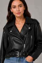 Women’s faux leather biker jacket with an asymmetric zip front, adjustable belted waist, zipped pockets and a relaxed cropped moto silhouette.
