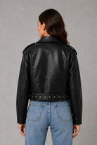 Women’s faux leather biker jacket with an asymmetric zip front, adjustable belted waist, zipped pockets and a relaxed cropped moto silhouette.