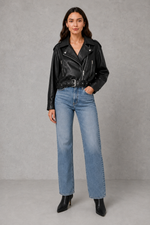 Women’s faux leather biker jacket with an asymmetric zip front, adjustable belted waist, zipped pockets and a relaxed cropped moto silhouette.