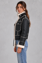 Women’s cropped aviator jacket with an oversized faux shearling collar, plush lining, flap chest pockets and adjustable drawcord hem.