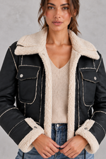 Women’s cropped aviator jacket with an oversized faux shearling collar, plush lining, flap chest pockets and adjustable drawcord hem.