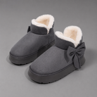 Women's faux suede winter boot slippers with plush fleece lining, side bow detail, cushioned platform sole and non-slip outsole, designed for warm, comfortable indoor wear and light outdoor use during autumn and winter.