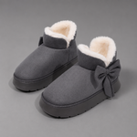 Women's faux suede winter boot slippers with plush fleece lining, side bow detail, cushioned platform sole and non-slip outsole, designed for warm, comfortable indoor wear and light outdoor use during autumn and winter.