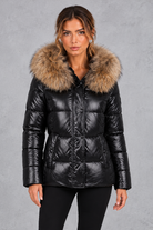Women's fitted puffer jacket with faux fur hood in Black – front view