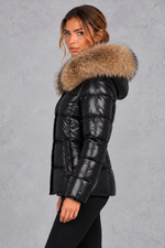 Women's fitted puffer jacket with faux fur hood in Black – side view