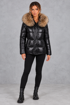 Women's fitted puffer jacket with faux fur hood in Black – full-length view