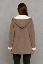 Women’s fleece-lined toggle coat with hood, designed for warm and cosy autumn and winter wear.