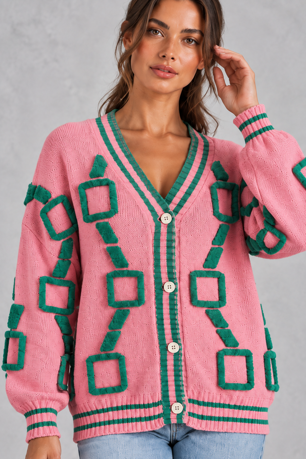 Women’s geometric knit cardigan with a deep V-neckline, button front, dropped shoulders and contrast striped ribbed trims.