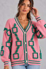 Women’s geometric knit cardigan with a deep V-neckline, button front, dropped shoulders and contrast striped ribbed trims.