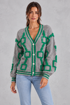 Women’s geometric knit cardigan with a deep V-neckline, button front, dropped shoulders and contrast striped ribbed trims.