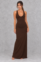 Women’s halter backless bodycon maxi dress with delicate spaghetti straps, gold ring detailing and a sleek fitted silhouette.