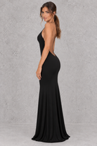 Women’s halter backless bodycon maxi dress with delicate spaghetti straps, gold ring detailing and a sleek fitted silhouette.