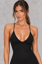 Women’s halter backless bodycon maxi dress with delicate spaghetti straps, gold ring detailing and a sleek fitted silhouette.