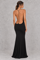 Women’s halter backless bodycon maxi dress with delicate spaghetti straps, gold ring detailing and a sleek fitted silhouette.