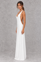 Women’s halter backless bodycon maxi dress with delicate spaghetti straps, gold ring detailing and a sleek fitted silhouette.