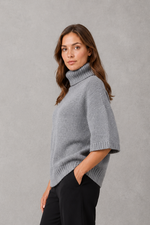 Women’s high neck batwing knit jumper with textured waist-cinching design for autumn and winter.