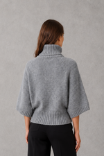 Women’s high neck batwing knit jumper with textured waist-cinching design for autumn and winter.
