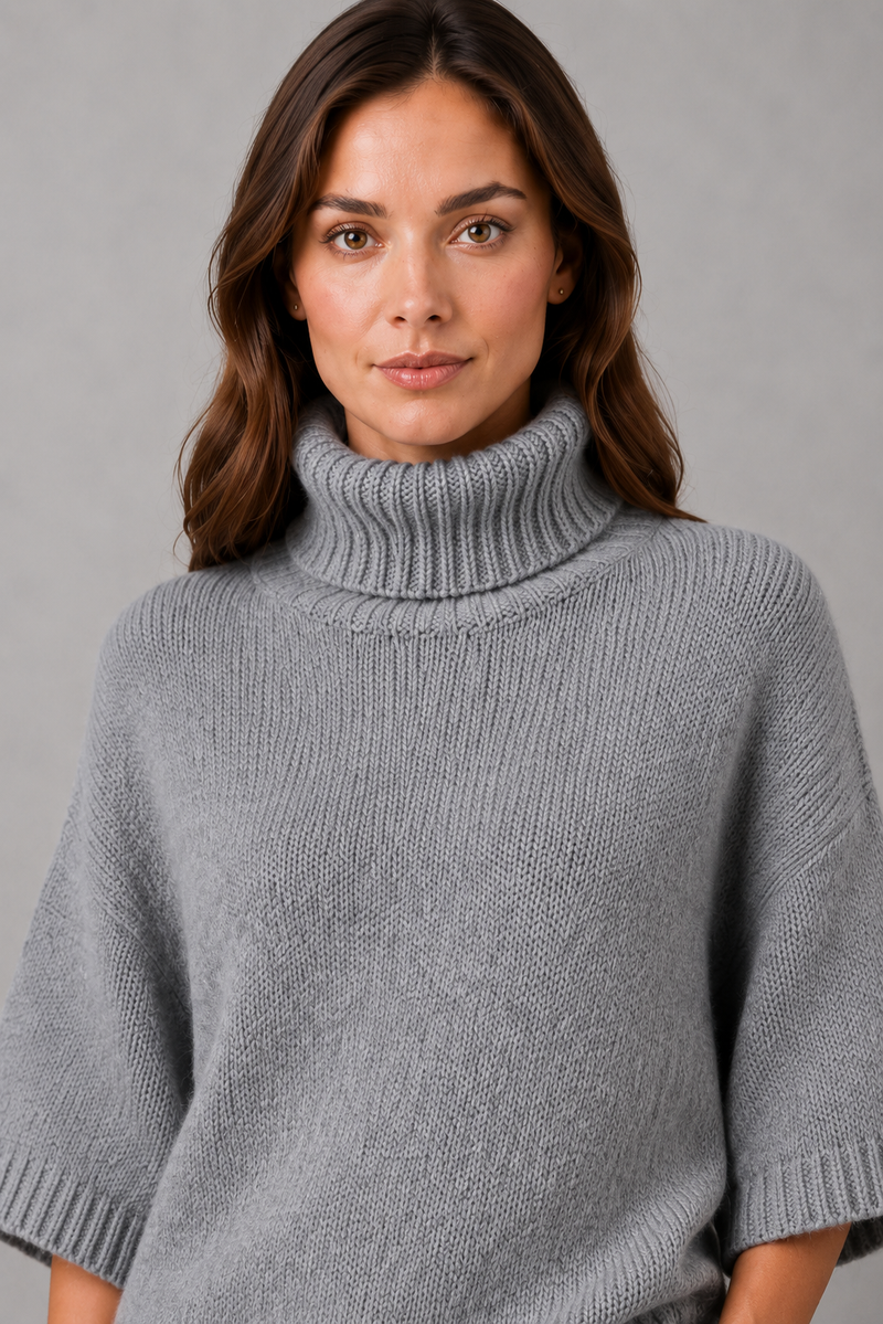 Women’s high neck batwing knit jumper with textured waist-cinching design for autumn and winter.