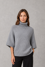 Women’s high neck batwing knit jumper with textured waist-cinching design for autumn and winter.