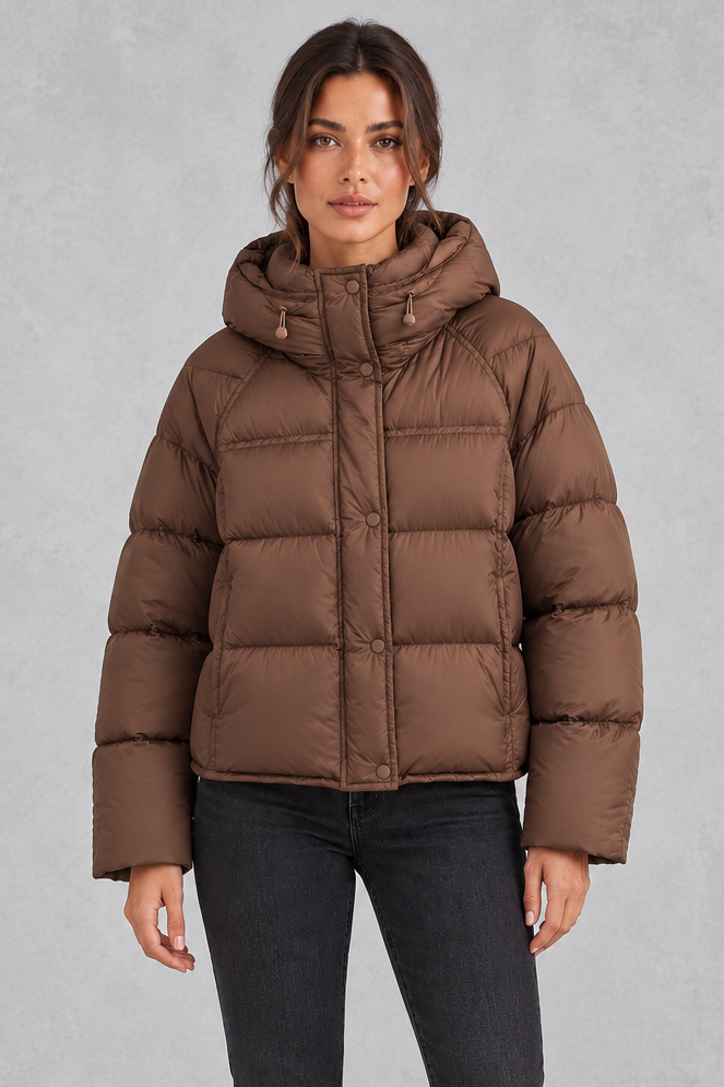 Women’s hooded puffer jacket with generous padding, a large hood, high protective neckline, long sleeves and relaxed silhouette.
