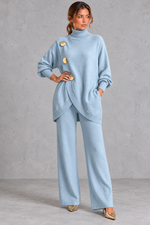 Women's light blue knitted turtleneck jumper and wide leg trouser set with gold buttons – front view