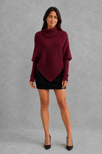 Women’s high neck knit jumper with oversized batwing sleeves, rib-knit texture and an asymmetric split hem.