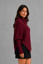 Women’s high neck knit jumper with oversized batwing sleeves, rib-knit texture and an asymmetric split hem.