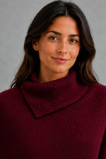 Women’s high neck knit jumper with oversized batwing sleeves, rib-knit texture and an asymmetric split hem.