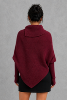 Women’s high neck knit jumper with oversized batwing sleeves, rib-knit texture and an asymmetric split hem.