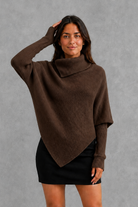 Women’s high neck knit jumper with oversized batwing sleeves, rib-knit texture and an asymmetric split hem.